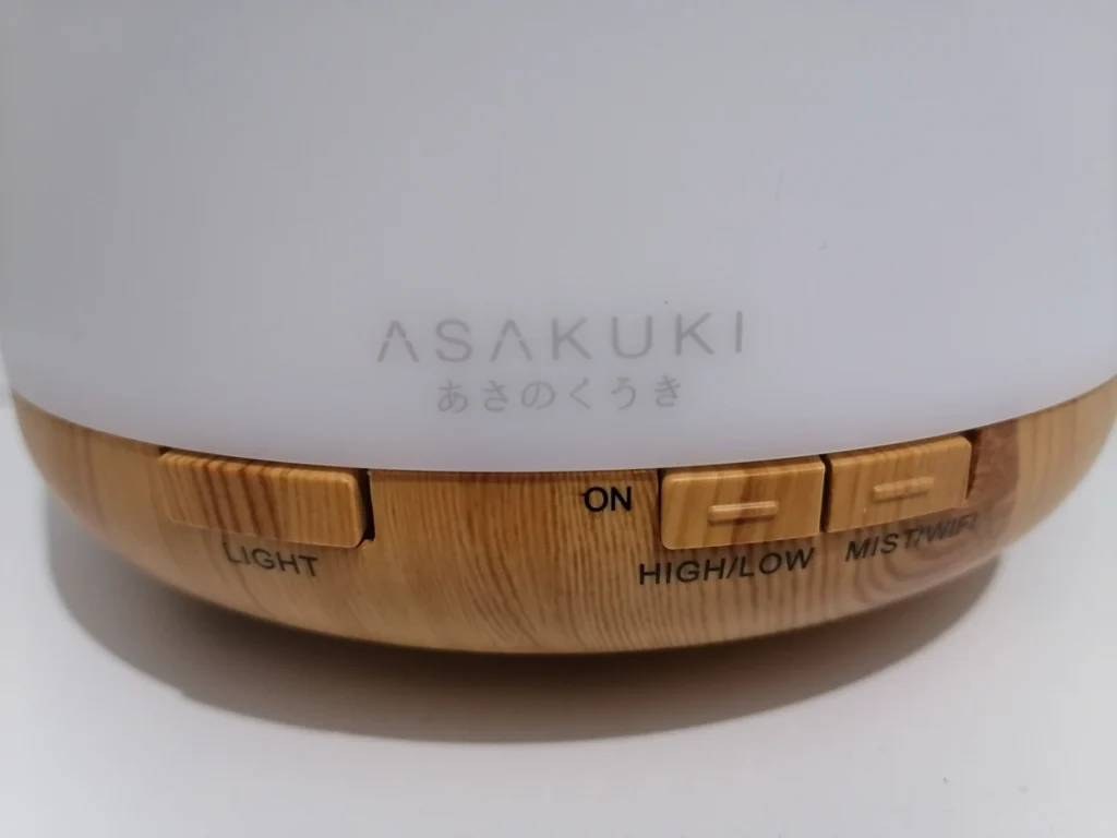 close-up of asakuki diffuser base showing light, on, high/low and mist/wifi control buttons