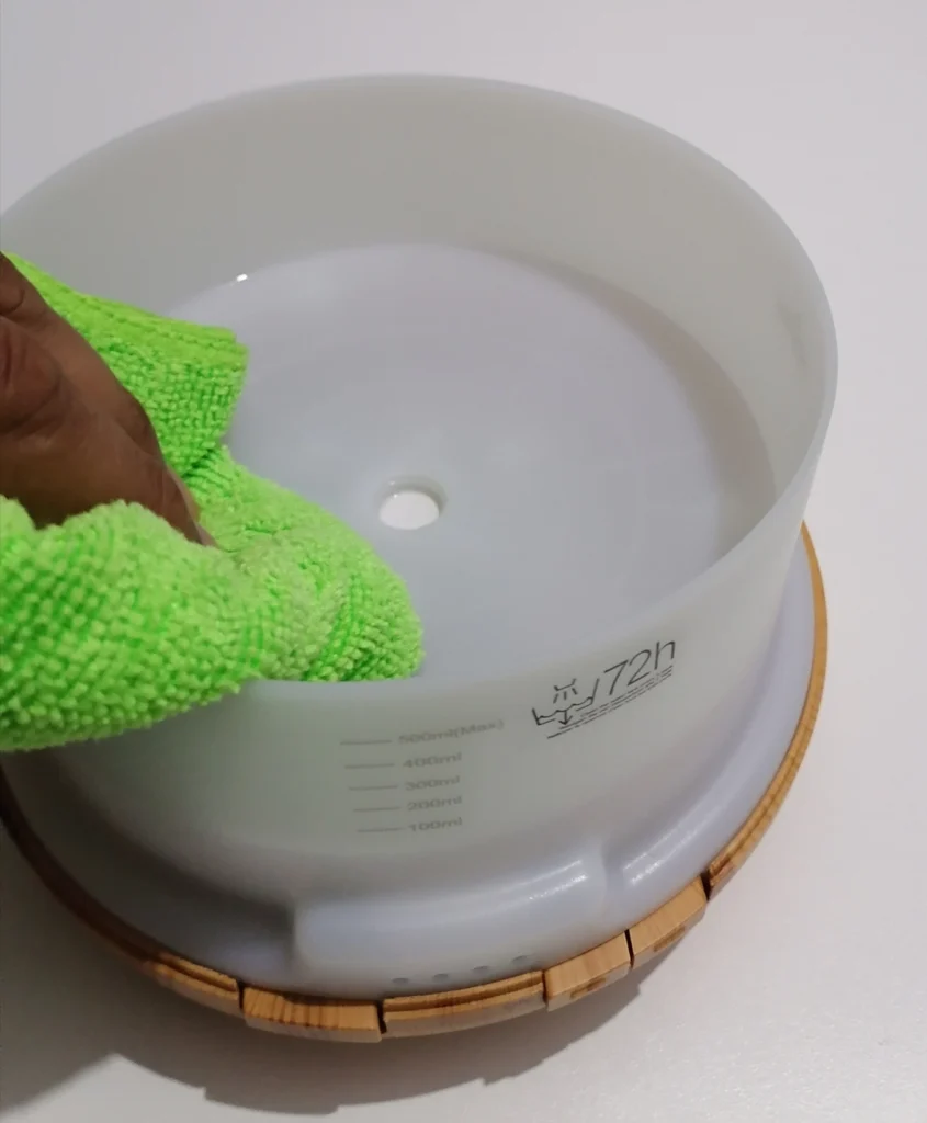 wiping the interior of the asakuki diffuser tank with a microfibre cloth