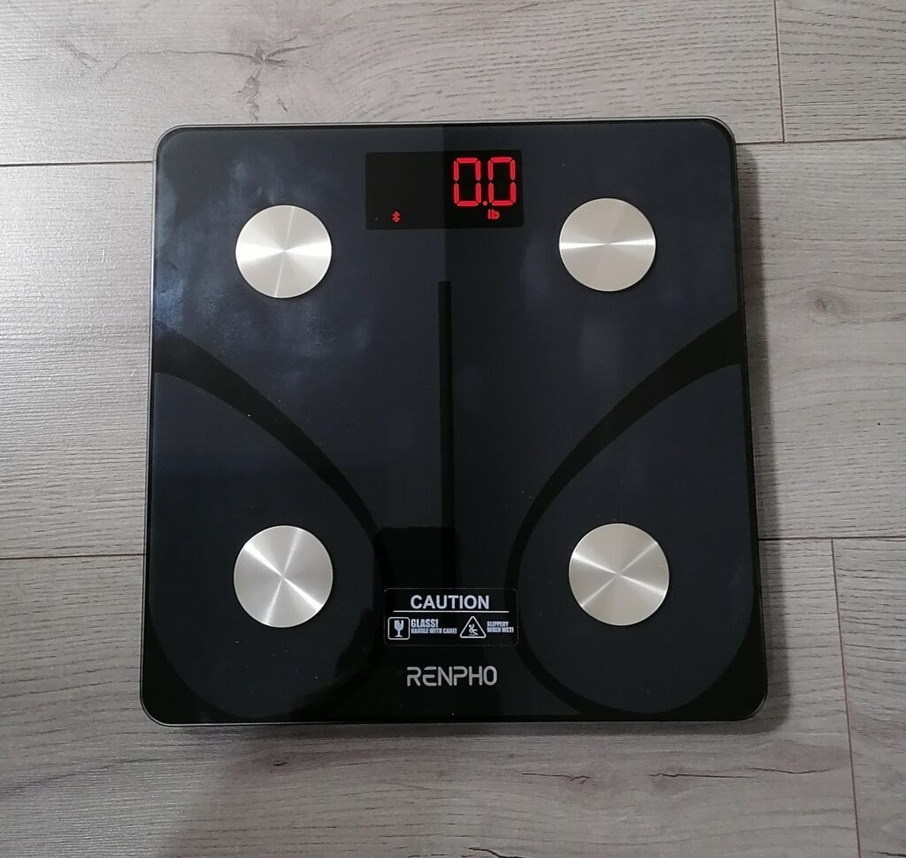 renpho elis 1 smart scale powered on displaying 0.0 lb with bluetooth active