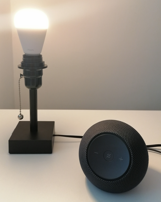 aqara t2 bulb glowing warm white in lamp next to echo dot max